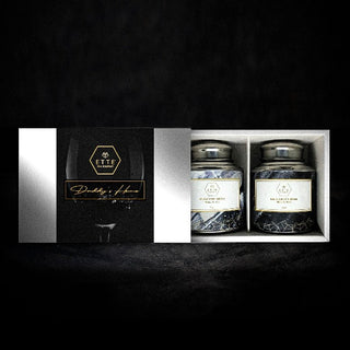 rectangular white box with a black wrap around label with ETTE TEA logo on it and product name Daddy's Home for father's day. Inside the box sits Moscow Muletea caddy to the left, Kris grey creme to the right. The box is set infront of a black background